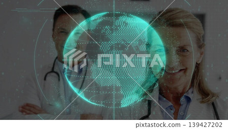 Posing senior doctor in white coat with stethoscope and doctor behind, teal globe, copy space Posing senior doctor in white coat with stethoscope and doctor behind, teal globe, copy space 139427202