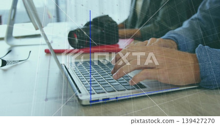 Typing male hands wearing long sleeve blue shirt on light desk, with silver laptop and DSLR Typing male hands wearing long sleeve blue shirt on light desk, with silver laptop and DSLR 139427270