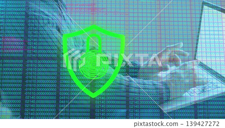 Reclining man wearing long-sleeve top and jacket using laptop on sofa, green shield padlock overlay Reclining man wearing long-sleeve top and jacket using laptop on sofa, green shield padlock overlay 139427272