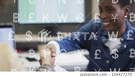 Shaking right woman in denim reaching across office with PC, docs and currency overlay, copy space Shaking right woman in denim reaching across office with PC, docs and currency overlay, copy space 139427278