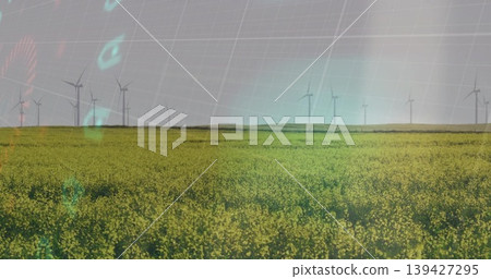 Stretching broad canola field covering farmland, showing wind turbines and teal grid overlay Stretching broad canola field covering farmland, showing wind turbines and teal grid overlay 139427295