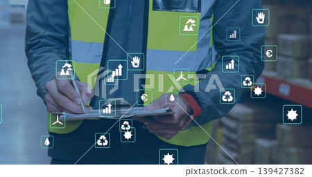 Inspecting worker in yellow vest noting clipboard with pen in warehouse racks, showing AR icons Inspecting worker in yellow vest noting clipboard with pen in warehouse racks, showing AR icons 139427382