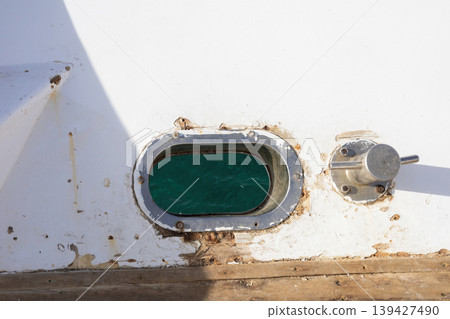 Nautical view through boat window with turquoise water Nautical view through boat window with turquoise water 139427490