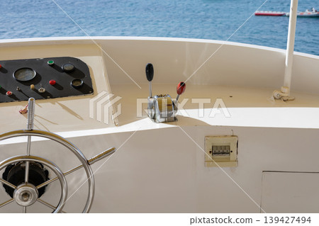 Nautical vessel control panel overlooking serene ocean waters Nautical vessel control panel overlooking serene ocean waters 139427494