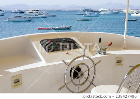 Scenic view of yacht wheel and boats in tranquil blue waters for boating enthusiasts 139427496