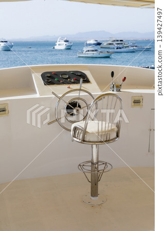 Luxury yacht steering wheel and sea view for nautical adventures and marine relaxation Luxury yacht steering wheel and sea view for nautical adventures and marine relaxation 139427497