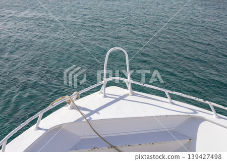 Serene ocean view from boat bow on a sunny day Serene ocean view from boat bow on a sunny day 139427498