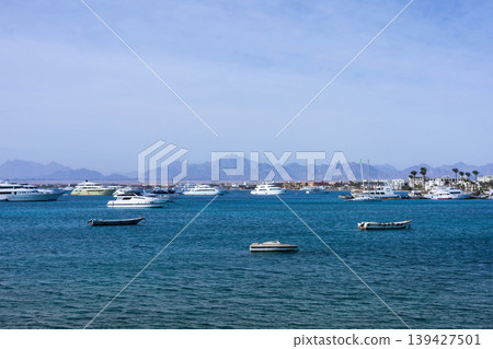 Serene seascape with boats and yachts on a tranquil blue ocean Serene seascape with boats and yachts on a tranquil blue ocean 139427501