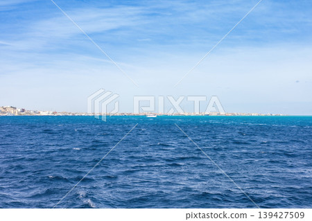Expansive ocean horizon and clear blue sky capturing serenity and calm 139427509