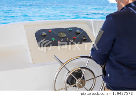 Captivating maritime journey with sailor steering boat in open sea Captivating maritime journey with sailor steering boat in open sea 139427578