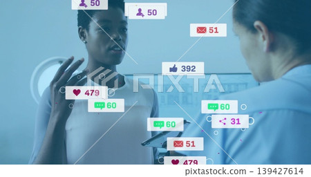 Woman in white sleeveless top gesturing in cool blue studio, with tablet and social metrics Woman in white sleeveless top gesturing in cool blue studio, with tablet and social metrics 139427614