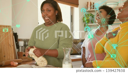 Kneading woman in green top shaping dough at home counter, milk, friends white or yellow, teal overl Kneading woman in green top shaping dough at home counter, milk, friends white or yellow, teal overl 139427638