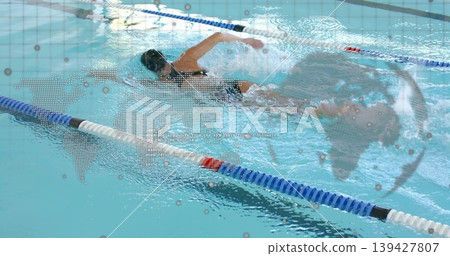 Swimming woman in dark one-piece suit and goggles slicing through lap pool lane, with map overlay Swimming woman in dark one-piece suit and goggles slicing through lap pool lane, with map overlay 139427807
