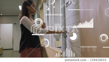 Reaching woman wearing office outfit touching handle in office corridor, with keycard, tote, HUD Reaching woman wearing office outfit touching handle in office corridor, with keycard, tote, HUD 139428033
