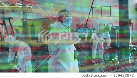 Cleaning female staff in white coverall spraying disinfectant at gym, with stock chart overlay 139428078