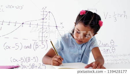 Blue-top pink-clips girl writing math in class using yellow-pencil notebook or whiteboard or purple- Blue-top pink-clips girl writing math in class using yellow-pencil notebook or whiteboard or purple- 139428177