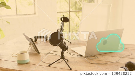 Showcasing black condenser microphone on tripod at home table, with laptop cloud graphic and tablet Showcasing black condenser microphone on tripod at home table, with laptop cloud graphic and tablet 139428232