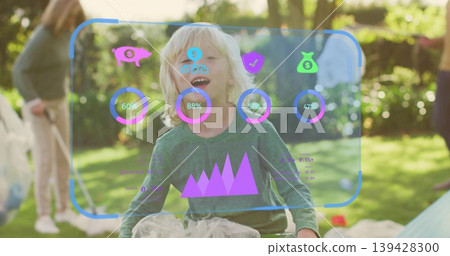 Laughing child wearing green top and tulle playing in sunlit backyard with AR HUD and bubbles Laughing child wearing green top and tulle playing in sunlit backyard with AR HUD and bubbles 139428300
