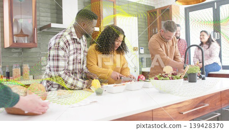 Chopping woman in mustard knit sweater preparing salad at large white kitchen island with knives Chopping woman in mustard knit sweater preparing salad at large white kitchen island with knives 139428370
