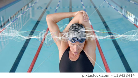 Stretching female swimmer holding arms behind head in lap pool, in swimsuit, cap, goggles, waveform Stretching female swimmer holding arms behind head in lap pool, in swimsuit, cap, goggles, waveform 139428414