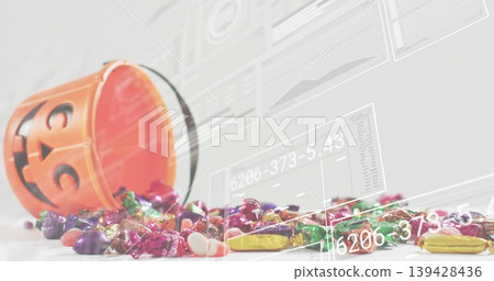 Tipping orange jack-o-lantern bucket spilling assorted candies on white table with digital overlays Tipping orange jack-o-lantern bucket spilling assorted candies on white table with digital overlays 139428436