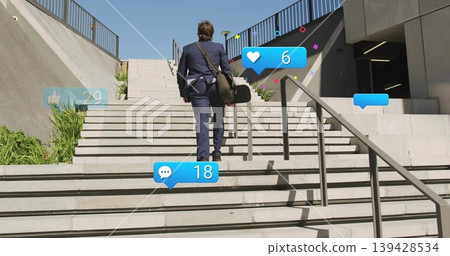 Climbing man in navy suit ascending concrete stairs, carrying shoulder bag with social icons Climbing man in navy suit ascending concrete stairs, carrying shoulder bag with social icons 139428534