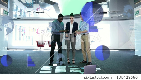 Reviewing three professionals in business attire pointing at charts on carpet with tablets, laptop Reviewing three professionals in business attire pointing at charts on carpet with tablets, laptop 139428566
