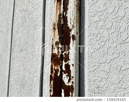 Metal pillars of a building with peeling paint and severe rust. Metal pillars of a building with peeling paint and severe rust. 139429165