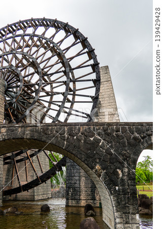 A giant wooden waterwheel stands tall at the Obaachan-ichi Yamaoka roadside station. A giant wooden waterwheel stands tall at the Obaachan-ichi Yamaoka roadside station. 139429428