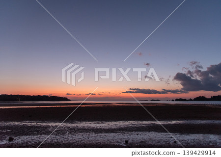 A shallow tidal flat after sunset on a clear day. A shallow tidal flat after sunset on a clear day. 139429914