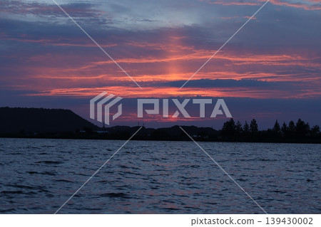 The evening sky over Lake Koyama is painted in the twilight hours after sunset. The evening sky over Lake Koyama is painted in the twilight hours after sunset. 139430002