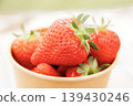 Lots of fresh strawberries in a cup 139430246