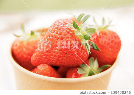 Lots of fresh strawberries in a cup 139430246