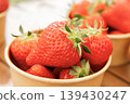 Lots of fresh strawberries in a cup 139430247