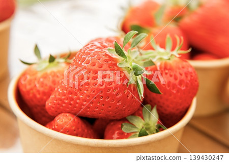 Lots of fresh strawberries in a cup 139430247
