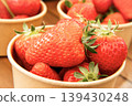 Lots of fresh strawberries in a cup 139430248