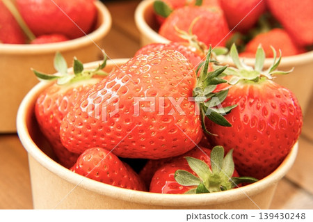 Lots of fresh strawberries in a cup 139430248