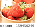Lots of fresh strawberries in a cup 139430249