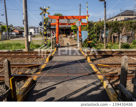 A shrine where a railway crossing is part of the approach to the shrine: A fusion of railway and religious space - Ukyozuka Shrine 139430486