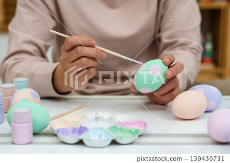 close up hand painting and decorating colorful egg at home on easter day close up hand painting and decorating colorful egg at home on easter day 139430731