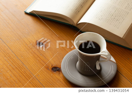 A peaceful afternoon of reading and coffee. 139431054