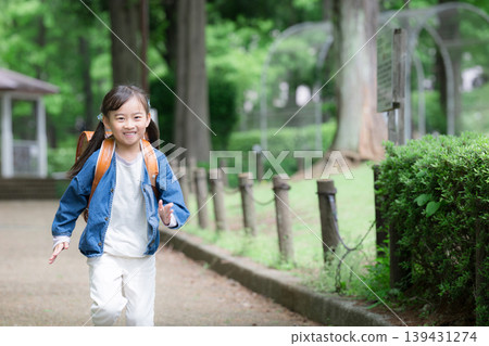 A full-body portrait of an energetic elementary school student running with a schoolbag, representing the school commute and growth of a young elementary school student going to and from school. A full-body portrait of an energetic elementary school student running with a schoolbag, representing the school commute and growth of a young elementary school student going to and from school. 139431274