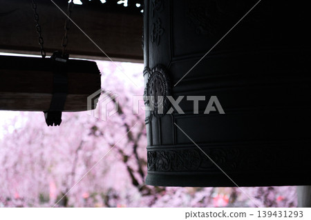A landscape with cherry blossoms and a temple bell. 139431293