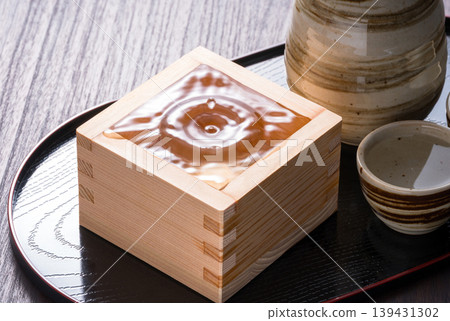 Sake in a wooden masu cup Sake in a wooden masu cup 139431302