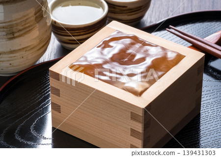 Sake in a wooden masu cup Sake in a wooden masu cup 139431303