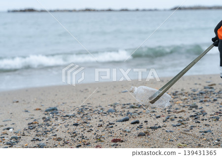 People picking up trash at the beach People picking up trash at the beach 139431365