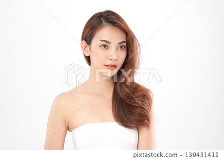 A beautiful young Asian woman with clean, fresh skin against a white background. Skincare, facial treatment, cosmetology, beauty, and spa. An elegant portrait of an Asian woman. A beautiful young Asian woman with clean, fresh skin against a white background. Skincare, facial treatment, cosmetology, beauty, and spa. An elegant portrait of an Asian woman. 139431411