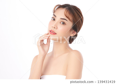 A beautiful young Asian woman with clean, fresh skin against a white background. Skincare, facial treatment, cosmetology, beauty, and spa. An elegant portrait of an Asian woman. 139431419