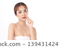 A beautiful young Asian woman with clean, fresh skin against a white background. Skincare, facial treatment, cosmetology, beauty, and spa. An elegant portrait of an Asian woman. 139431424