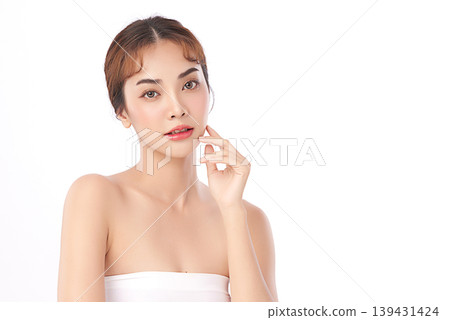 A beautiful young Asian woman with clean, fresh skin against a white background. Skincare, facial treatment, cosmetology, beauty, and spa. An elegant portrait of an Asian woman. 139431424